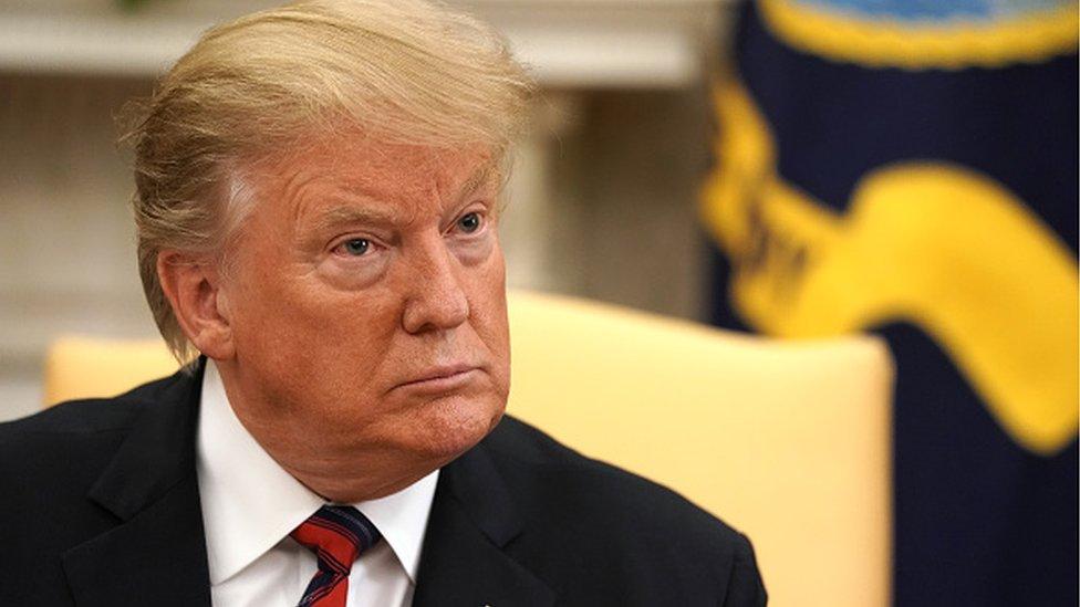 U.S. President Donald Trump talks to reporters at the White House