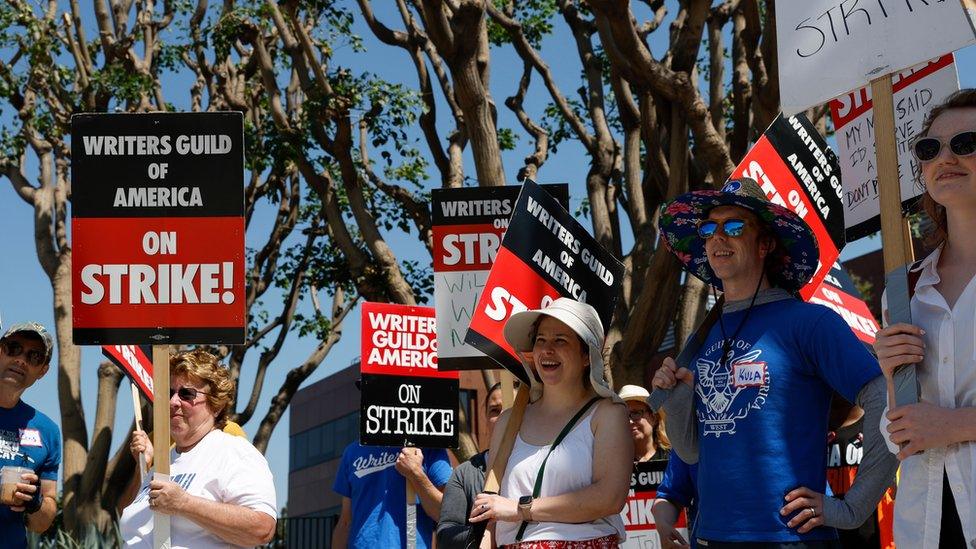 Picketers outside NBCUniversal's Barham Gate in Los Angeles last month