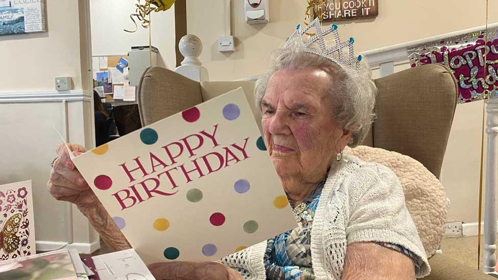 Millie Hopkins reads a birthday card