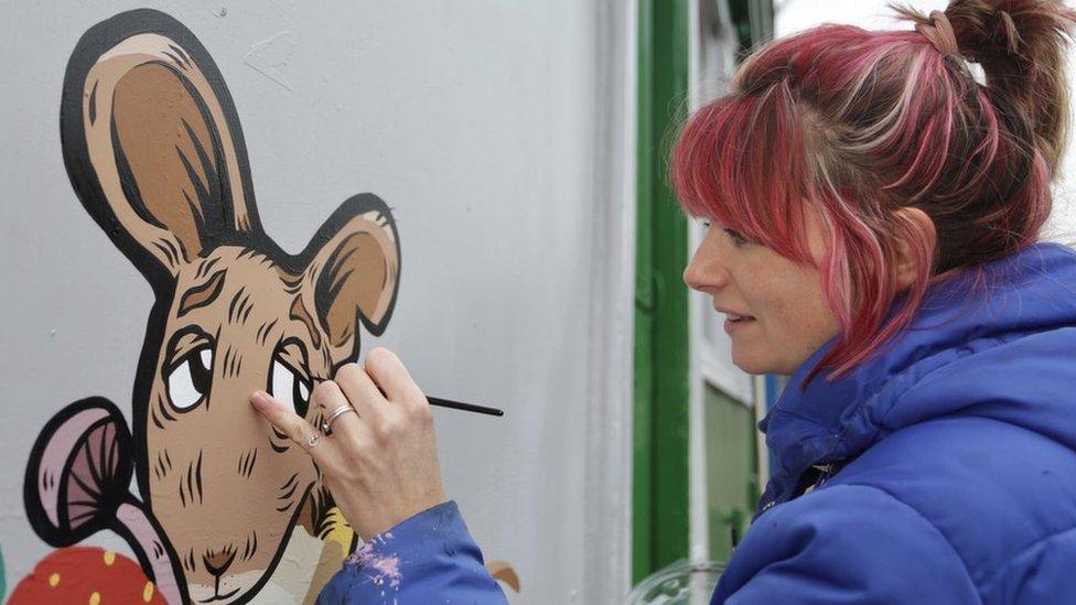 Artist Alex Lucas painting film character