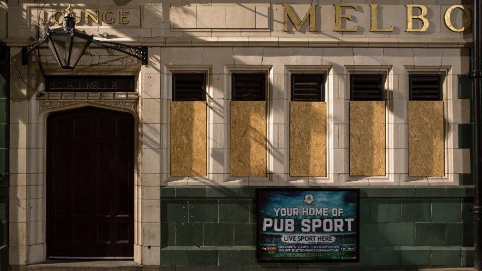 Shuttered windows of a closed pub