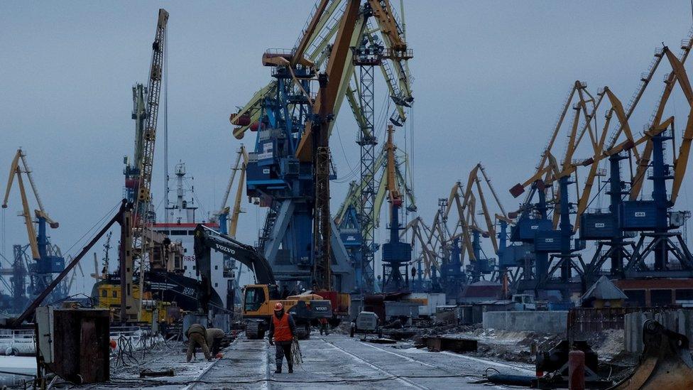 Cranes are seen in huge numbers in a bleak and cold port - with very little activity taking place