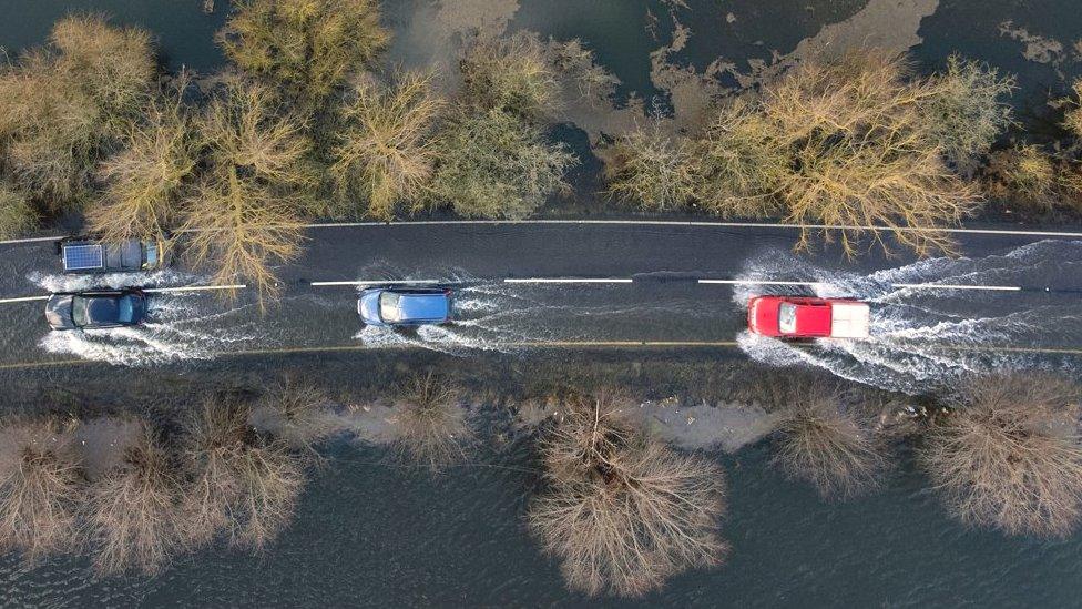 Cars on the A1101 in floodwater on Sunday