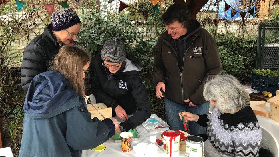 Members of the community painting