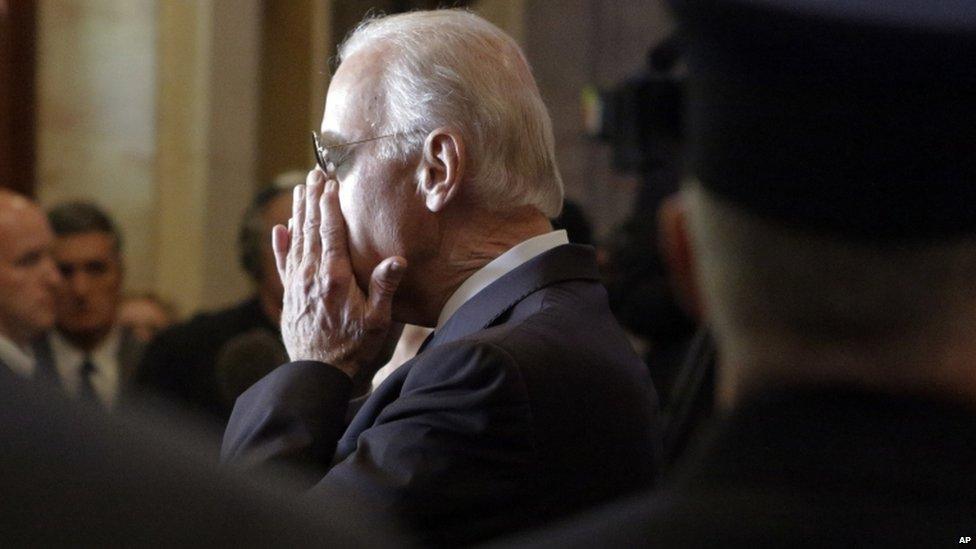 Vice President Joe Biden composes himself as the casket of his son, Beau Biden, is placed in a hearse at the conclusion of his funeral in Wilmington on 6 June 2015