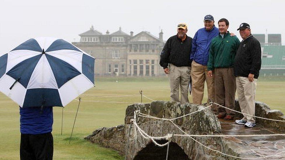 US tourists pose for a picture on the Swilcan Bridge at the famous St Andrews course in Scotland