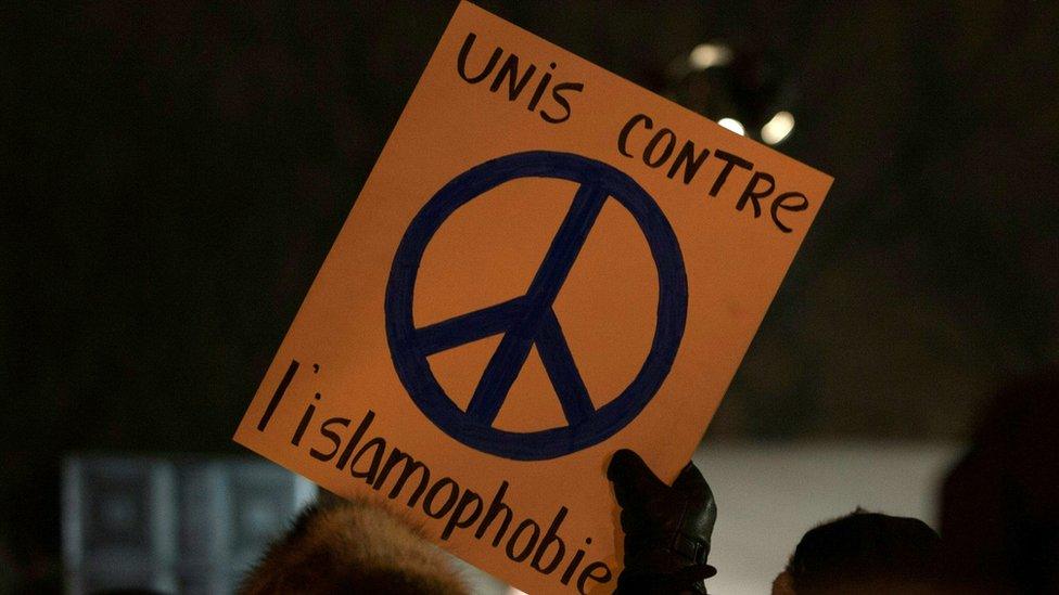 A person holds a sign 'United against Islamophobia'