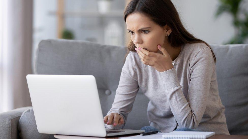 Woman reading laptop