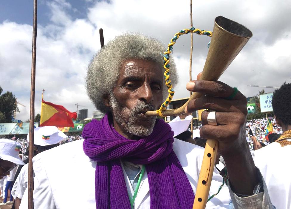 Man blowing a horn