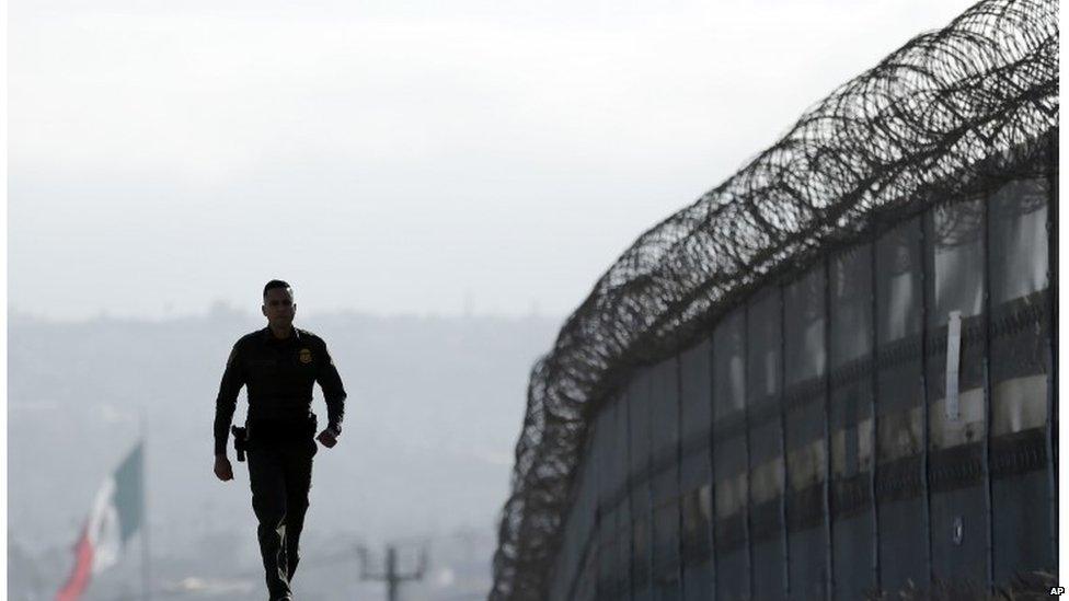 US border official patrolling the fence separating Tijuana in Mexico and San Diego in San Diego