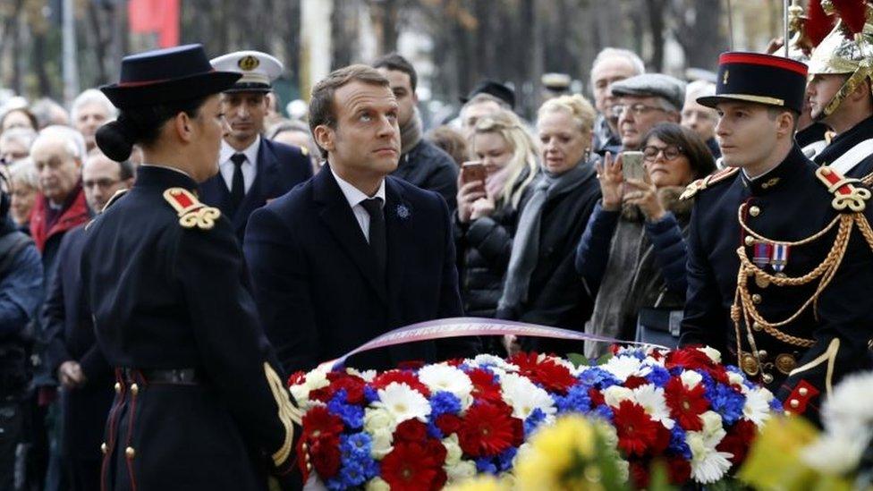 French President Emmanuel Macron lays a wreath in front of the statue of Georges Clemenceau in Paris