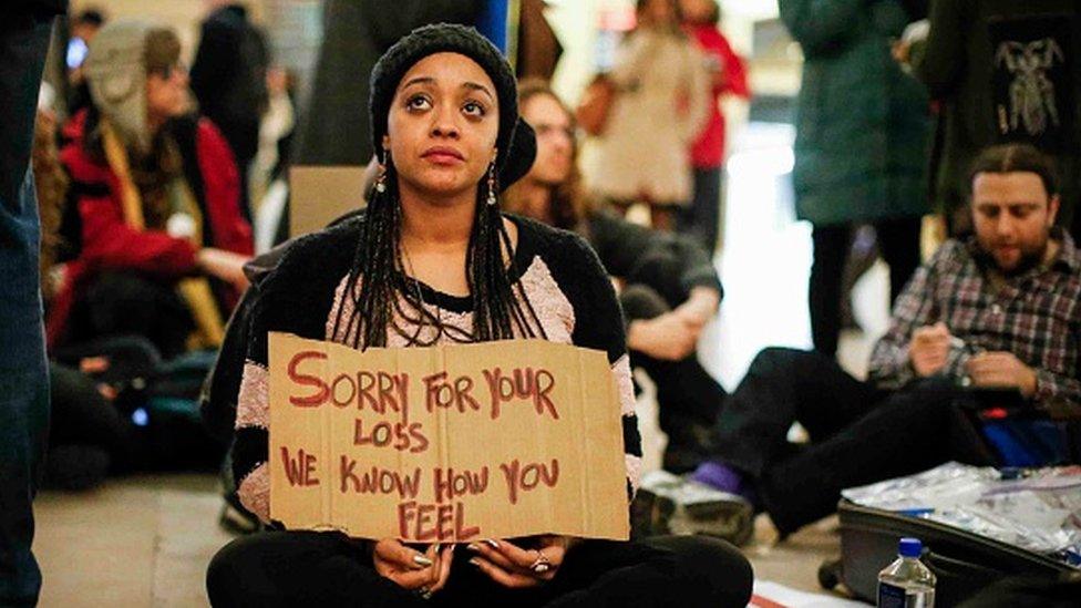 Woman holding a sign during memorial