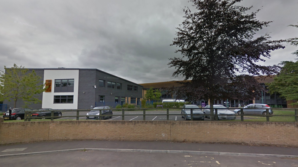 school buildings with a large tree