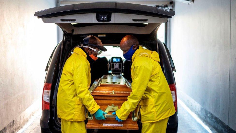 Undertakers holding a coffin