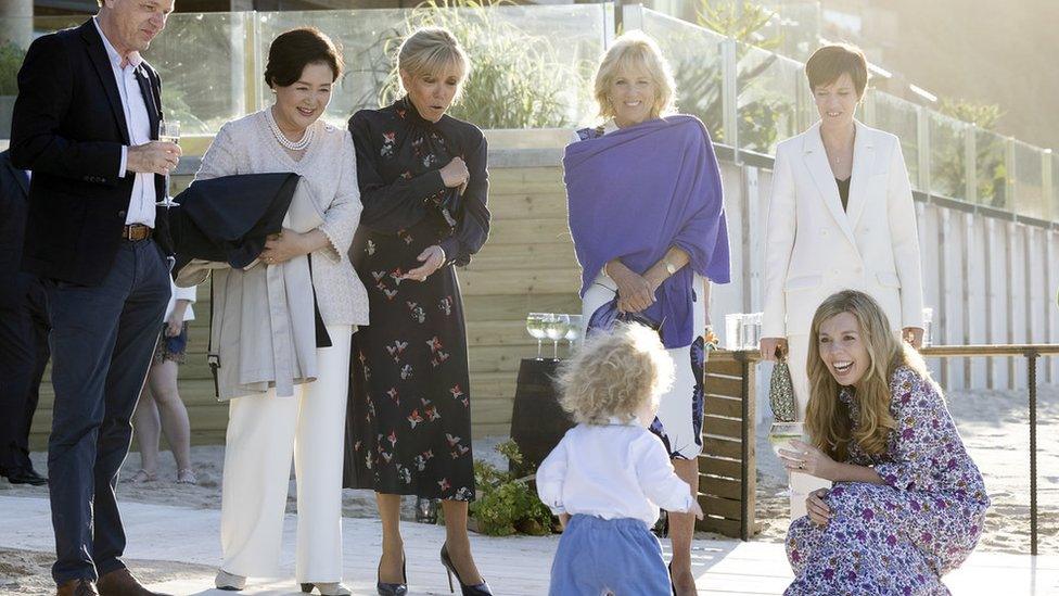 Carrie Johnson with Wilfred Johnson as Kim Jung-Sook, Jill Biden, Brigitte Macron look on