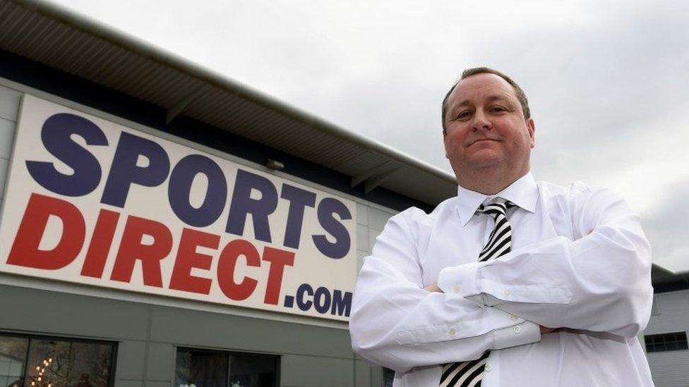 Mike Ashley standing outside his warehouse in Derbyshire