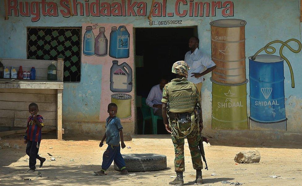 AU soldier outside a shop