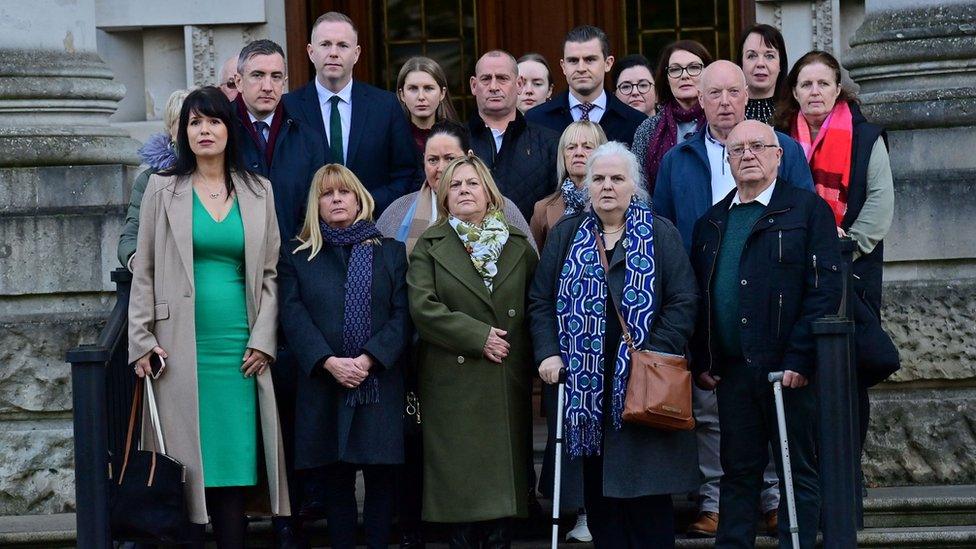 Families of Troubles victims stand outside Belfast's High Court