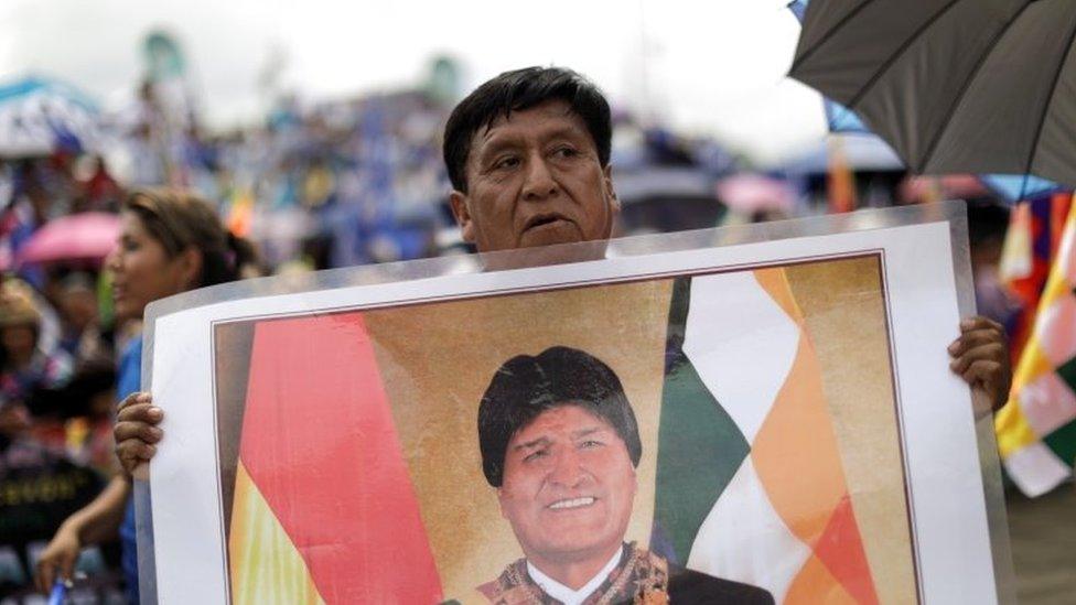 A supporter holds a photo of Bolivia's former President Evo Morales during his caravan after returning to the country, in Chimore, Bolivia November 11, 2020.