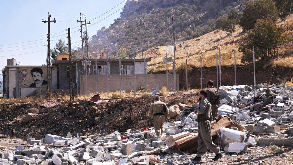 Iranian Komala party fighters inspect damage caused by Iranian Revolutionary Guards missile and drone strikes in Iraq's Kurdistan Region on 28 September 2022