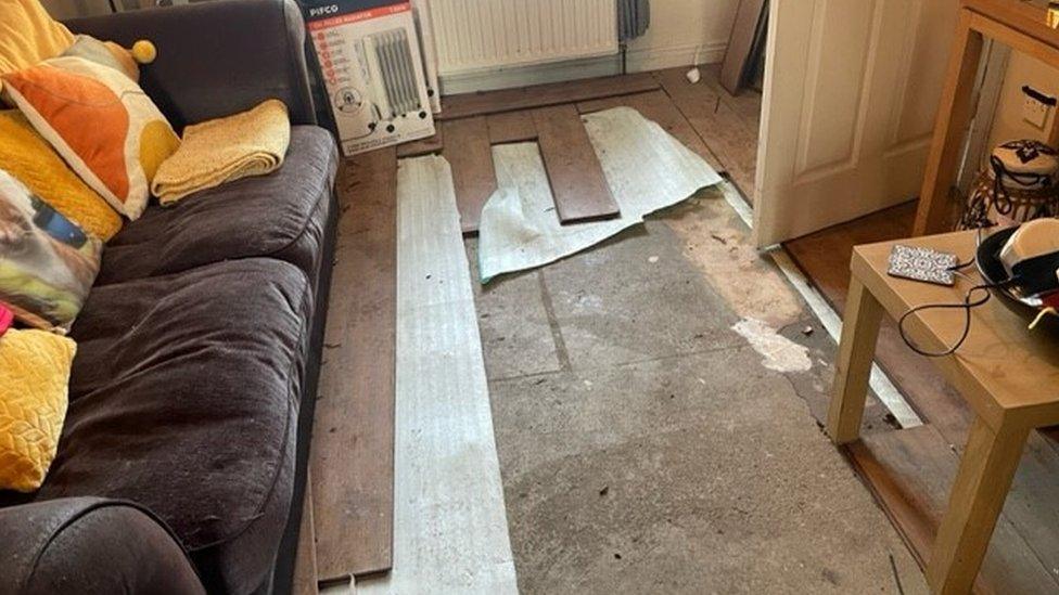 Brian Toal's house, showing damaged floorboards from floodwater