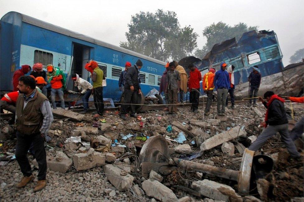 Rescue workers search for survivors at the site of Sunday"s train derailment in Pukhrayan, south of Kanpur city, India November 21, 2016.