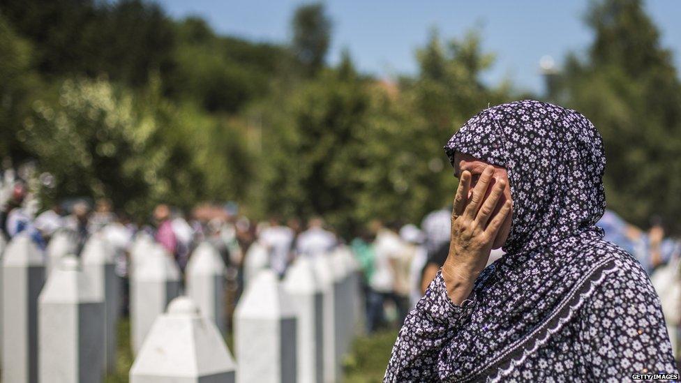 A woman mourns after the mass funeral for 136 newly-identified victims of the 1995 Srebrenica massacre attended by tens of thousands of mourners during the 20th anniversary of the massacre at the Potocari cemetery and memorial on 11 July 2015 in Srebrenica, Bosnia and Herzegovina