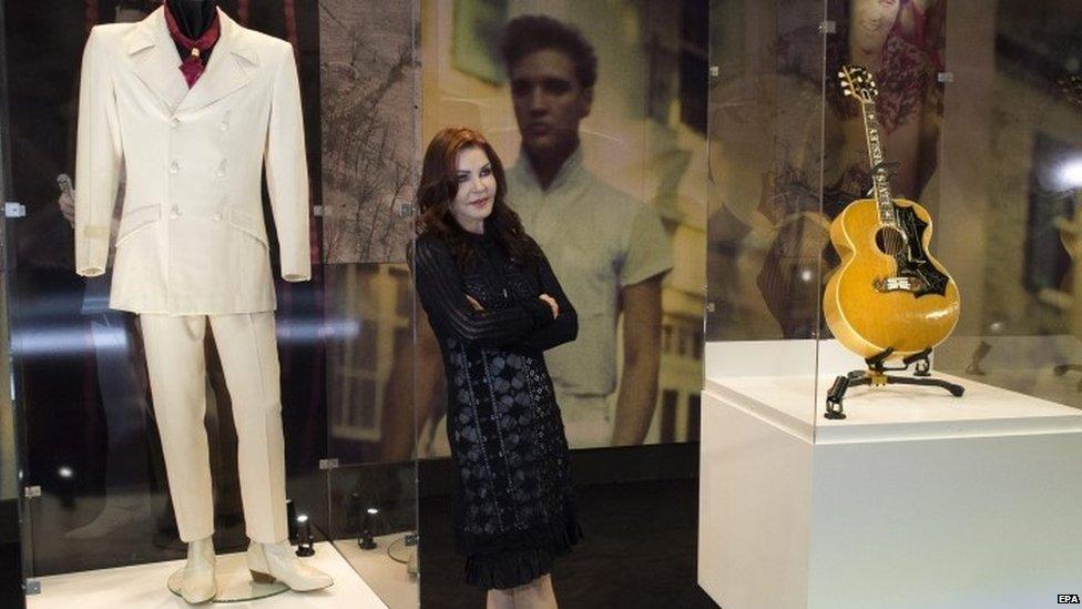 Priscilla Presley with the suit Elvis wore in 1968