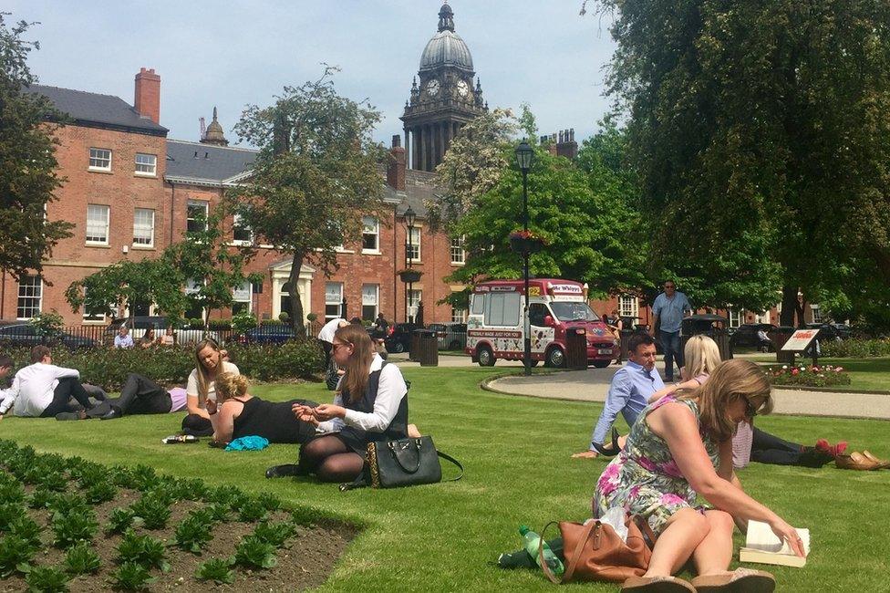 People enjoying the sunshine in Park Square, Leeds, West Yorkshire.