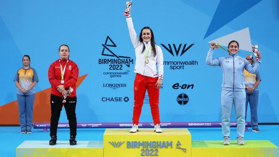 Silver medalist Alexis Ashworth of Team Canada, Gold medalist Sarah Davies of Team England and Bronze medalist Harjinder Kaur of Team India pose on the podium during the Women's 71kg - Final medal ceremony.