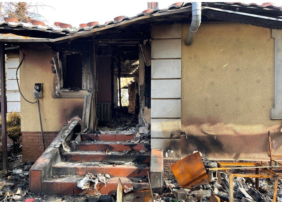 Ludmila's burnt-out house in a photo taken two years ago