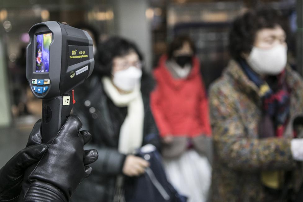 Attendees are checked using thermometers at a mass wedding ceremony organised by the Unification Church in South Korea.