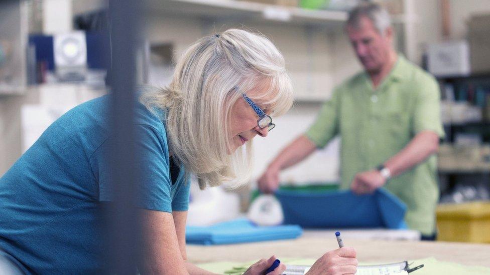 older woman and man at work