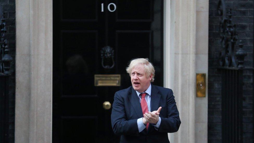 Prime Minister Boris Johnson applauds outside 10 Downing Street during the Clap for our Carers campaign in support of the NHS