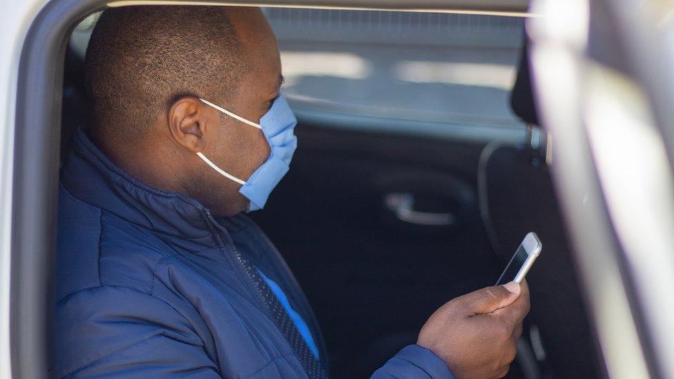 Man uses phone in taxi