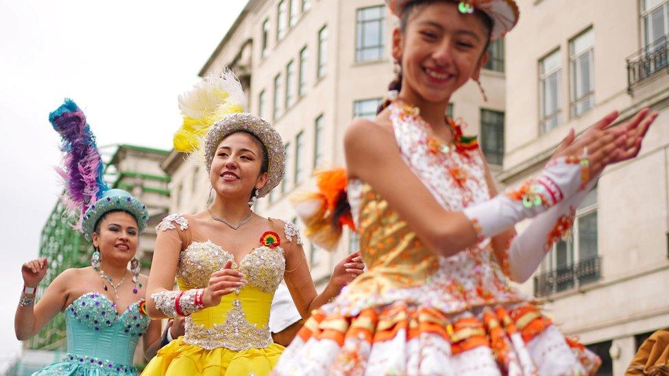 Performers dressed in colourful dresses take part in the New Year's Day Parade in London