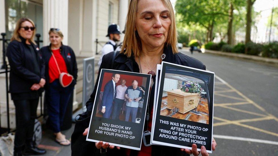 Lorelei King holding photos of her late husband who died in a care home