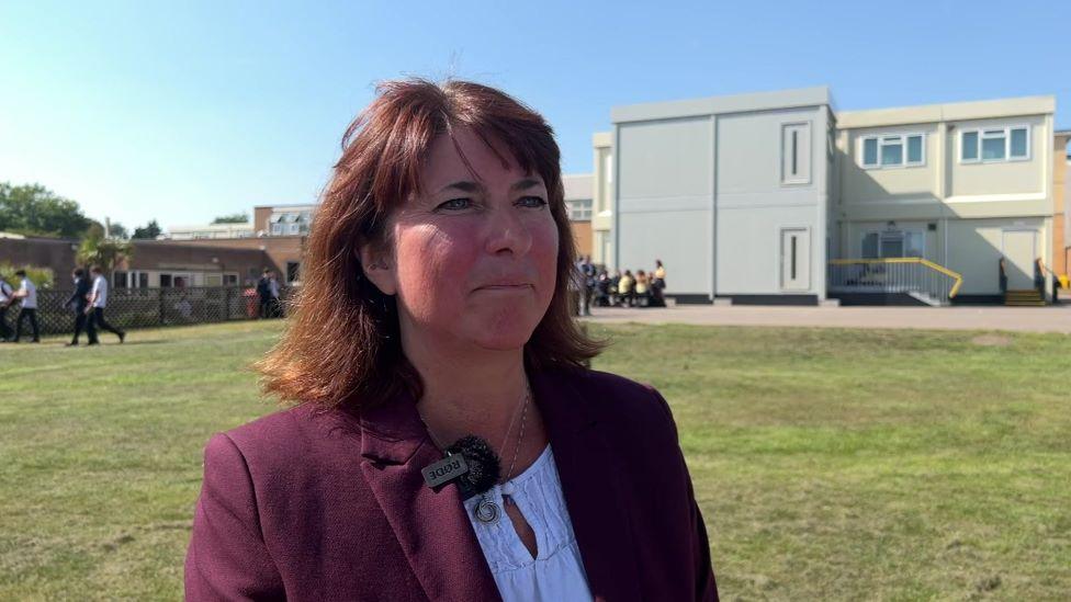 Headteacher Jody Gee stands in front of the temporary classrooms built at Anglo European School.