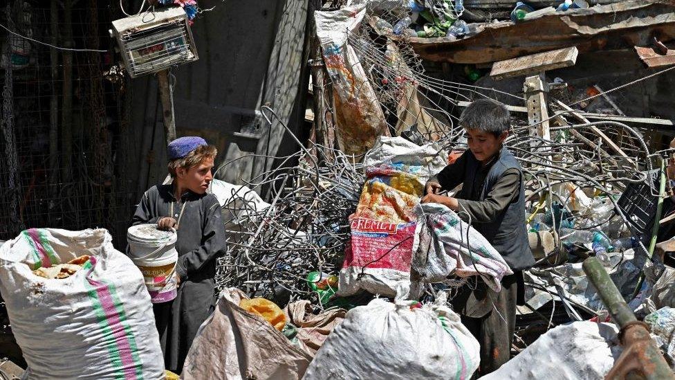 boys picking through rubbish