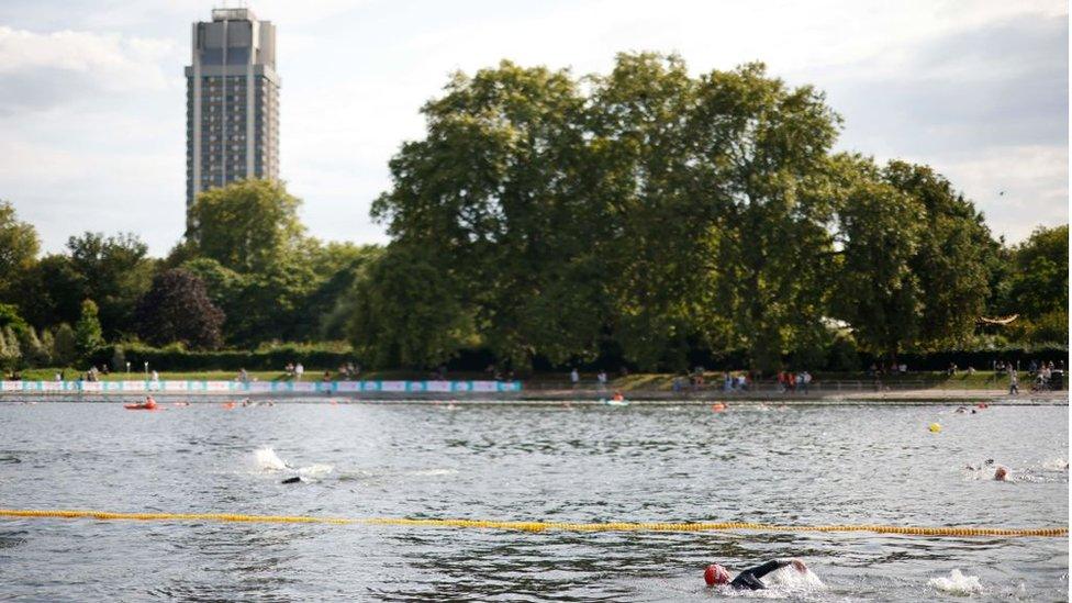 Swimmers participate in an open water swimming event, the 2021?Children with Cancer UK Swim Serpentine in Hyde Park in west London on September 18, 2021.