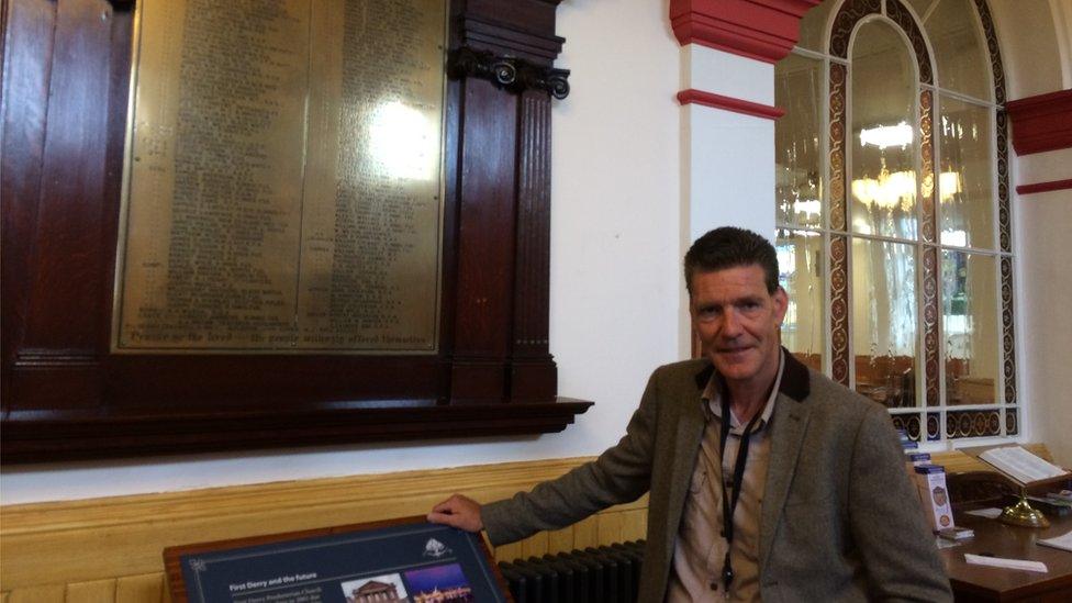 John Boyle beside plaque bearing his grandfather's name