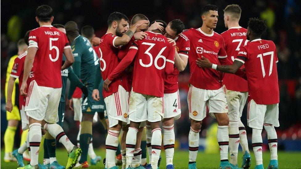 Manchester United"s Anthony Elanga is consoled by team-mates after missing the decisive penalty in the shoot-out after the Emirates FA Cup fourth round match at Old Trafford