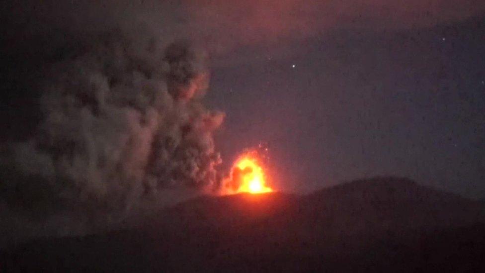 fire and ash above volcano crater