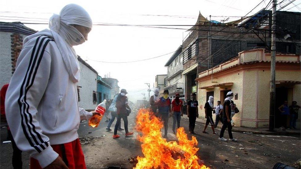 Students set fire barricades during a protest against Venezuelan President Nicolas Maduro's government, after the Supreme Court strongly limited the opposition-led National Assembly powers, in San Cristobal, Venezuela on March 2, 2016.