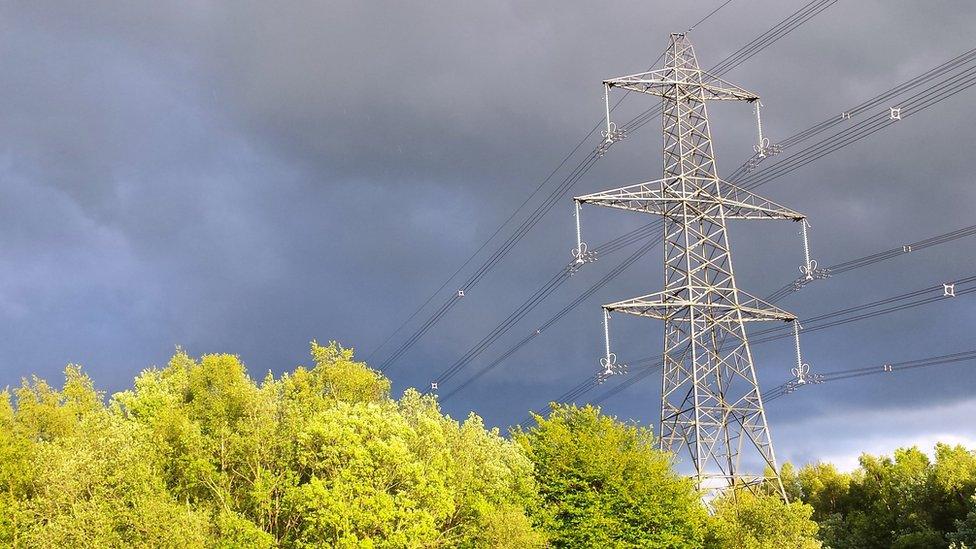 Pylon with clouds behind it