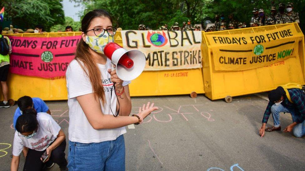 A protester seen making speeches through a megaphone, as they participate in a protest march during a global climate strike, part of the 'Fridays for Future' movement in New Delhi.