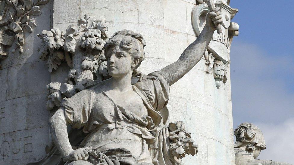 Liberty on the statue of bare-breasted Marianne is a prominent feature in the Place de la Republique in Paris