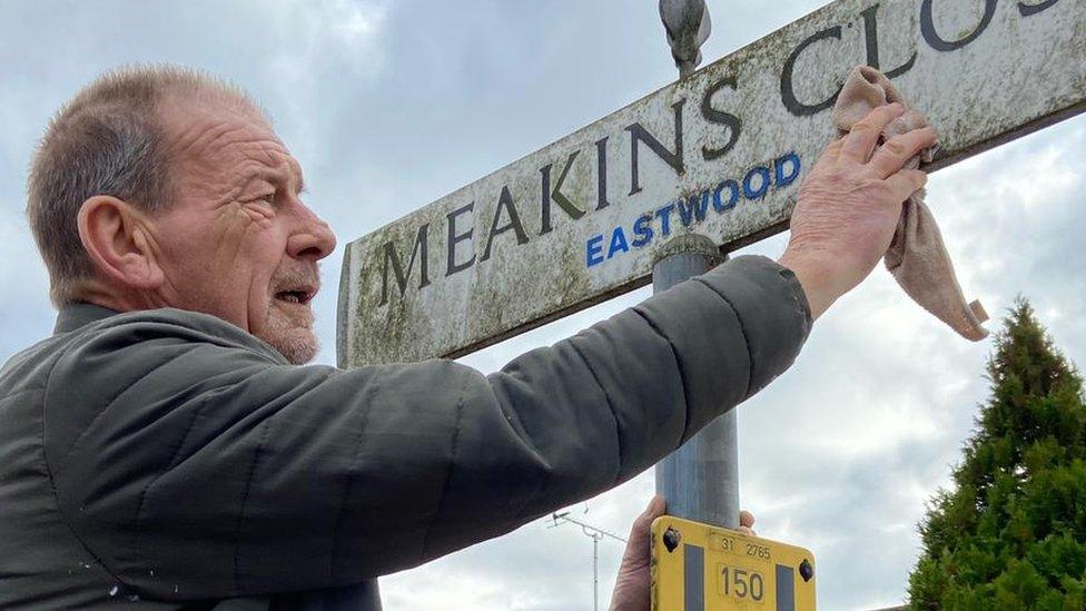 David McGlone cleaning signs