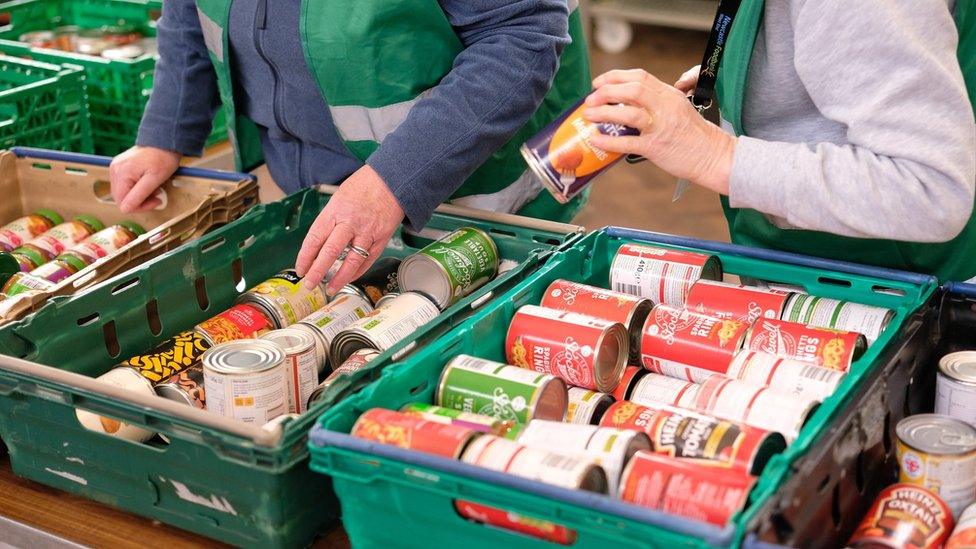 Volunteers from Newcastle West End Foodbank giving out parcels to clients at Venerable Bede Church Hall