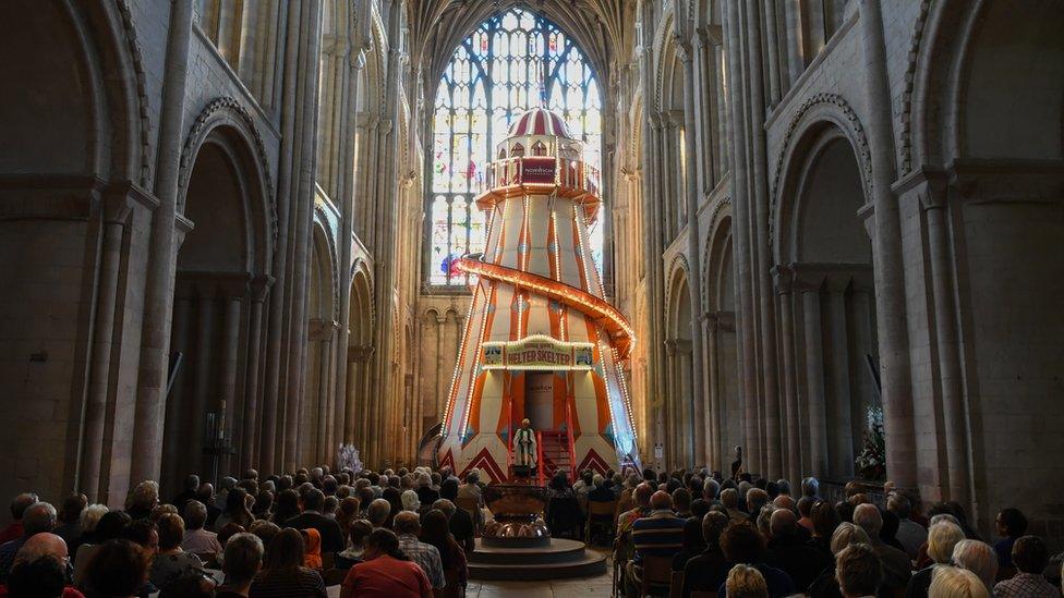 Congregation in front of helter-skelter